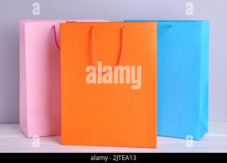 Colourful paper shopping bags on grey Stock Photo