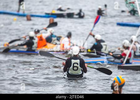 Canoe polo match, two teams play kayak polo game outdoor competition in
