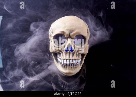 Humans skull with smoke isolated on black background. Death from smoke concept. Stock Photo