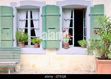 french style windows with green shutters Stock Photo