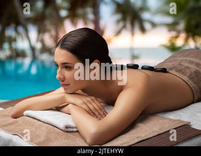 woman having hot stone massage at spa Stock Photo