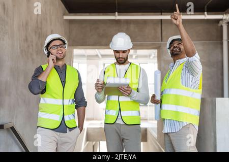 male architects in helmets working at office Stock Photo