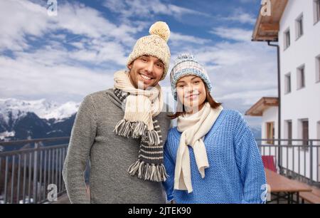 couple over mountains and ski resort in winter Stock Photo
