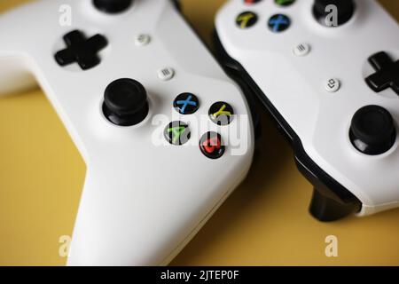 Two gaming gamepad buttons close-up on a yellow background Stock Photo
