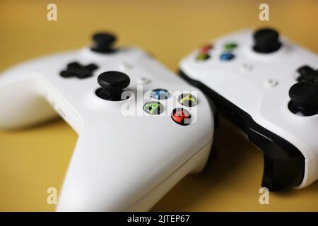 Two gaming gamepad buttons close-up on a yellow background Stock Photo