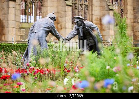 “All together now” statue by Andy Edwards, World War 1 Christmas truce soldiers played football. St Luke's 'Bombed Out' Church, Liverpool, UK Stock Photo