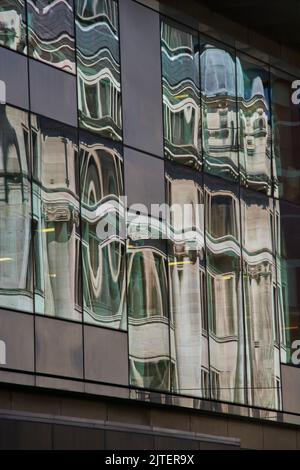 Manchester offices reflecting  in a glass window to mage abstract patterns Stock Photo