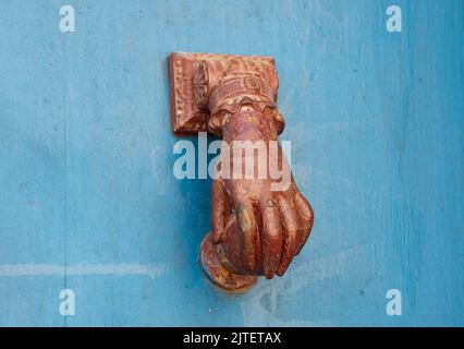Hand shaped door knocker Stock Photo