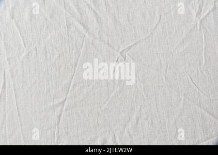 White crumpled linen cloth background. Stock Photo