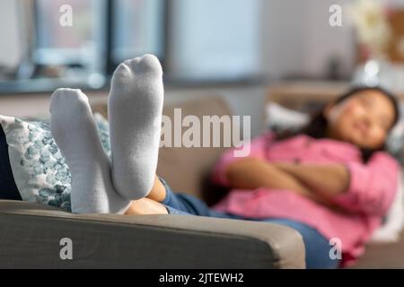 close up of feet of woman sleeping on sofa at home Stock Photo