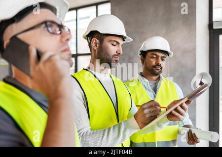 male architects in helmets working at office Stock Photo