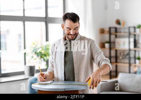 man with ruler measuring table for renovation Stock Photo