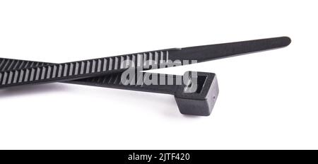 Black plastic cable ties isolated on white Stock Photo