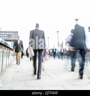 London Commuters. Abstract high-key long exposure blurs of London business and office workers on their way home during the morning rush hour.