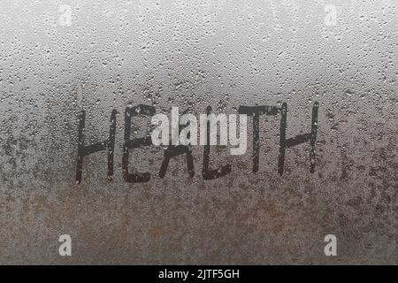 health word written on a window with raindrops Stock Photo