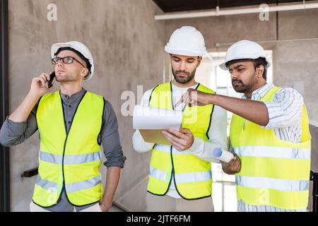 male architects in helmets working at office Stock Photo