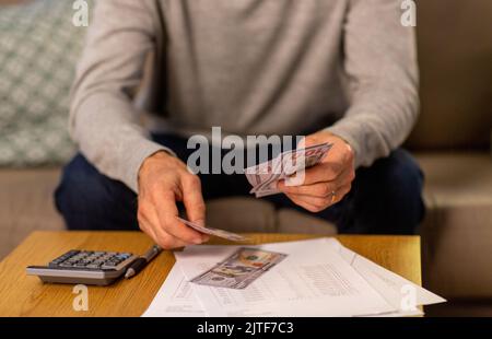 senior man counting money at home Stock Photo