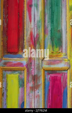Multi-colored painted real wooden door background with a pastel palette. Stock Photo