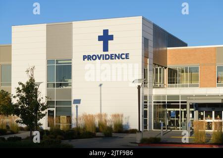 Monroe, WA, USA - August 29, 2022; Providnce health care location in Monroe Washington with blue sign and cross Stock Photo