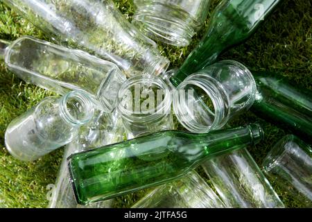 close up of empty glass bottles and jars on grass Stock Photo