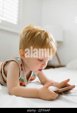 Boy (2-3) using smart phone Stock Photo
