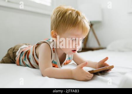 Boy (2-3) using smart phone Stock Photo