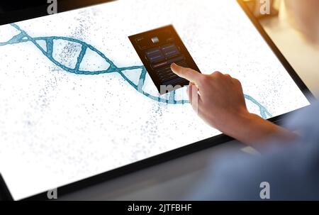 hand on led light tablet with dna molecule Stock Photo