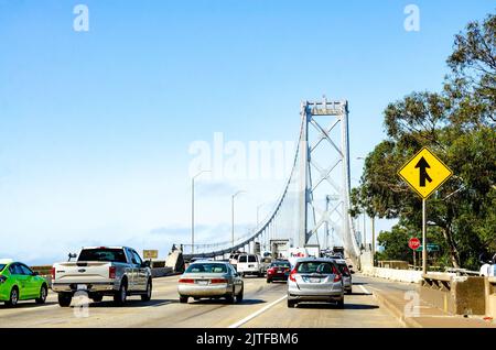 Driving across the San Francisco Oakland Bay Bridge on Highway 90 in California, USA under a clear, blue sky. Stock Photo