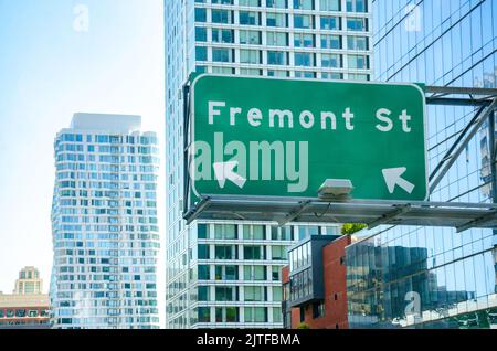 A large, green street sign for Fremont Street hanging from a modern glass office block in San Francisco, California, USA Stock Photo