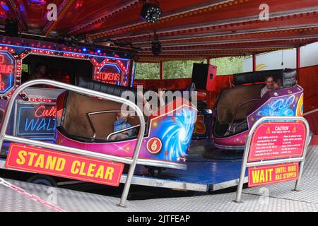 Ballycastle, United Kingdom. 30 Aug, 2022. Young children enjoying thrills of fairground ride, the closing day of Ireland's oldest fair in the seaside town of Ballycastle on the north coast of North Antrim wrapping up a bank holiday weekend of trading, and a programme packed with entertainment, local and international cuisine at The Ould Lammas Fair. Credit: Steve Nimmons/Alamy Live News Stock Photo