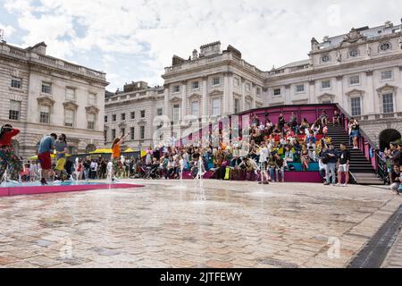 Spectators enjoying the This Bright Land performance in the neoclassical Somerset House Courtyard, London, England, UK Stock Photo