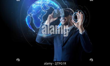 businessman in virtual reality headset over black Stock Photo