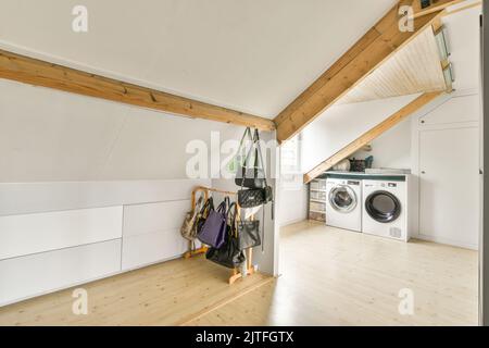 spacious mansard styled laundy room and storage Stock Photo