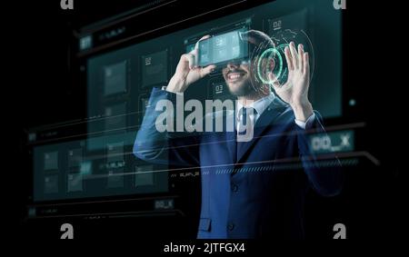 businessman in virtual reality headset over black Stock Photo