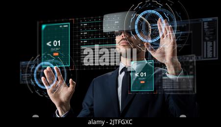 businessman in vr glasses using virtual screen Stock Photo
