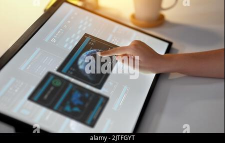 hand on led light tablet at night office Stock Photo