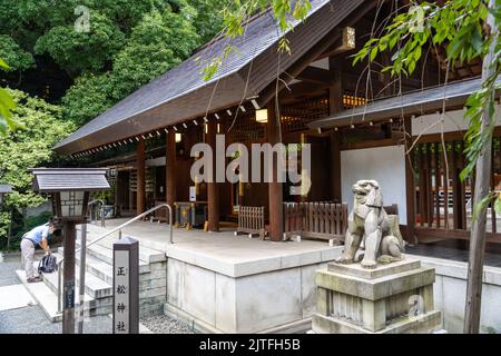 The Nogi-jinja Shrine main building with Komainu lion guardian statues, in Nogizaka, Akasaka, Tokyo, Japan. The small shrine is dedicated to General Nogi Maresuke and his wife Nogi Shizuko. Stock Photo