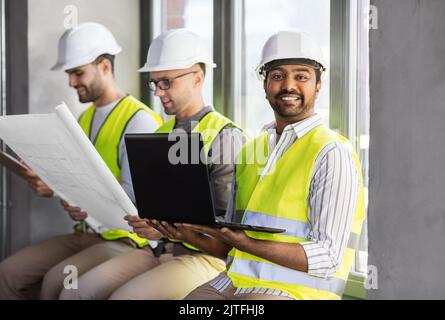 male architects in helmets working at office Stock Photo