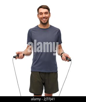 smiling man exercising with jump rope Stock Photo