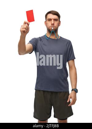 referee whistling whistle and showing red card Stock Photo