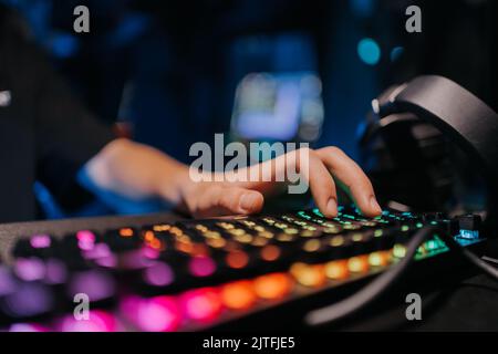 A professional e-sportsman plays games. Incognito Hacker. Stock Photo
