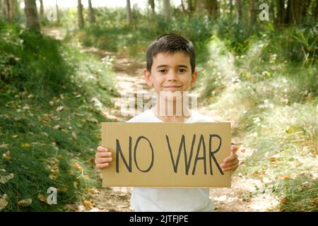 child displays 'no war' sign in the wild Stock Photo