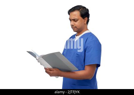 indian male doctor with medical report in folder Stock Photo
