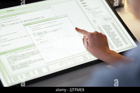 hand on led light tablet at night office Stock Photo