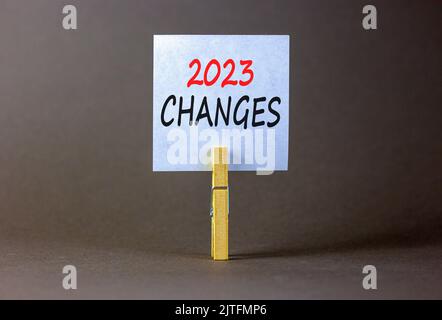 2023 Changes Symbol White Paper With Words 2023 Changes Clip On Wooden Clothespin Beautiful Grey Table Grey Background Business And 2023 Changes C 2jtfmp6 