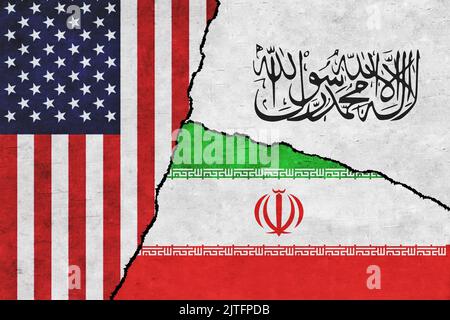 USA, Taliban and Iran painted flags on a wall with a crack. United States of America, Iran and Taliban relations. Afghanistan war. Islamic Emirate of Afghanistan Stock Photo
