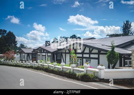 French style one-story wooden white townhouses against bright blue sky. Modern architecture in lovely contryside village. Beautiful classic provencal farmhouse - perfect property to live or invest. Stock Photo