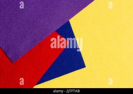 Abstract colorful geometric felt texture background. Bright yellow, blue, red, purple colors felt textile for craft. Top view, flat lay Stock Photo