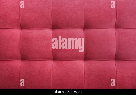 Red suede leather background for the wall in the room. Interior design, headboards made of furniture fabric, furniture upholstery. Classic checkered p Stock Photo