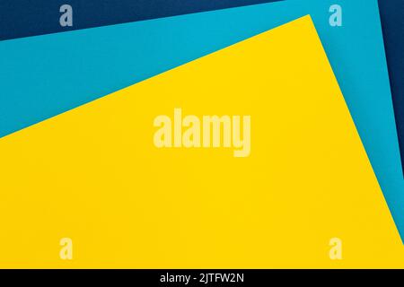 Abstract colored paper texture background. Minimal geometric shapes and lines in light blue, navy blue, yellow colors Stock Photo